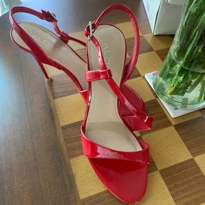 Aldo- Red patent strapped heels.